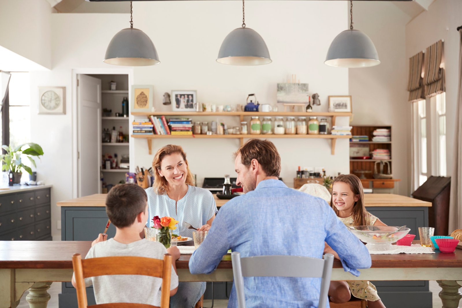 White family of four having lunch in their kitchen at home